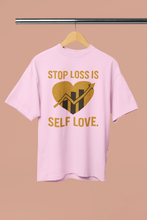 Pink t-shirt with a gold graphic and text on a beige background