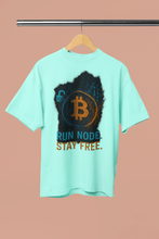 Mint green t-shirt with Bitcoin logo and text on a hanger against a beige background