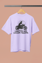 Light purple t-shirt with a graphic and text on a hanger against a beige background