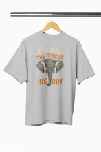 Gray t-shirt with elephant graphic and text on a hanger against a white background