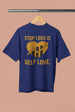 Blue t-shirt with yellow text and graphic on a hanger against a beige background