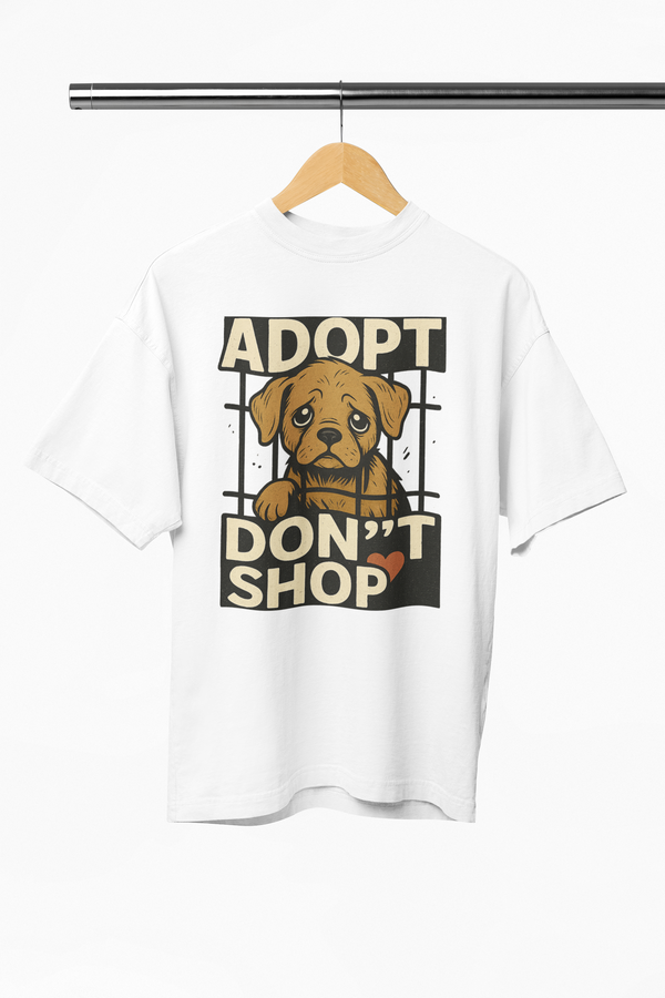 White t-shirt with a dog graphic and 'Adopt Don't Shop' text on a hanger.