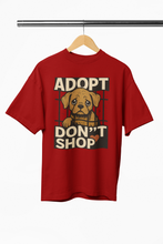 Red t-shirt with 'Adopt Don't Shop' graphic on a hanger against a white background