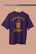Purple t-shirt with yellow graphic and text on a beige background