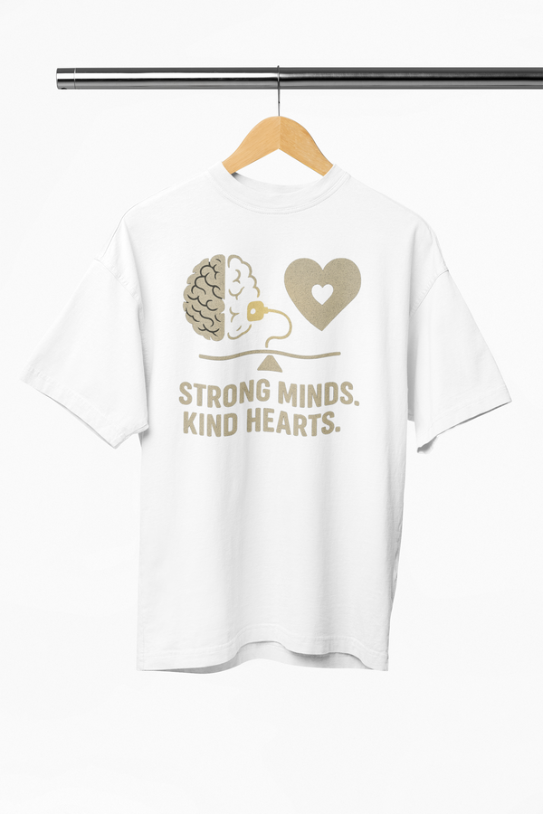White t-shirt with graphic design and text 'Strong Minds. Kind Hearts.' on a hanger.