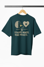 Green t-shirt with brain and heart design on a hanger against a white background