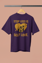 Purple t-shirt with yellow text and graphic on a beige background
