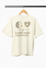 White t-shirt with graphic design and text on a hanger against a white background