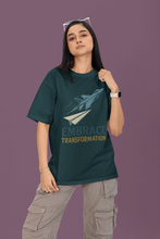 Person wearing a green t-shirt with a paper airplane graphic and text on a purple background