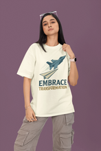 Person wearing a white t-shirt with a graphic and text on a purple background