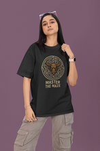 Person wearing a black t-shirt with a labyrinth design and 'Master the Maze' text on a purple background