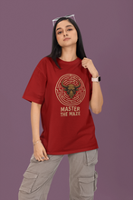 Person wearing a red t-shirt with a graphic design and text on a purple background