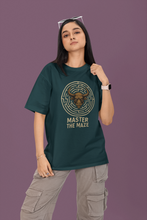 Person wearing a green t-shirt with a graphic design and text on a purple background