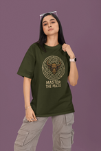 Person wearing a green t-shirt with a maze design and text on a purple background