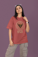 Person wearing a red t-shirt with a graphic design and text on a purple background