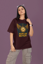 Person wearing a maroon t-shirt with a graphic design and text on a purple background