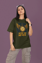Person wearing a green t-shirt with a clock design and 'Now or Never' text on a purple background