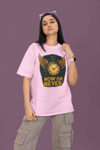 Person wearing a pink t-shirt with a graphic design and text on a purple background