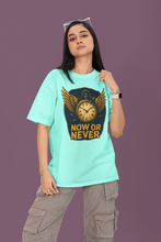 Person wearing a light blue t-shirt with a graphic design and text on a purple background