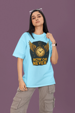 Person wearing a light blue t-shirt with a graphic design and text on a purple background