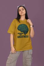 Person wearing a mustard yellow t-shirt with a brain graphic and text on a purple background