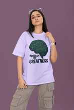 Person wearing a t-shirt with a brain graphic and 'Program for Greatness' text on a purple background