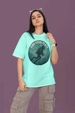 Person wearing a teal t-shirt with 'Find Your Peace' graphic design on a purple background