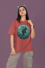 Person wearing a red t-shirt with a graphic design and text on a purple background