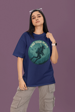 Person wearing a blue t-shirt with a graphic design and text on a purple background