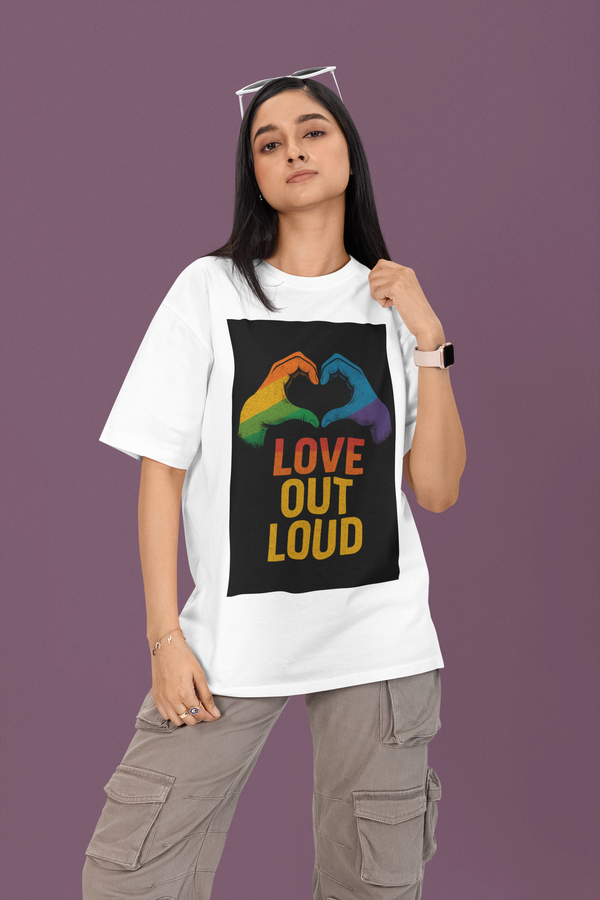 Person wearing a white t-shirt with a colorful 'LOVE OUT LOUD' design on a purple background
