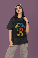 Person wearing a black t-shirt with a rainbow design and 'Love Out Loud' text on a purple background