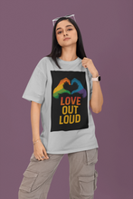 Person wearing a t-shirt with 'Love Out Loud' design on a purple background