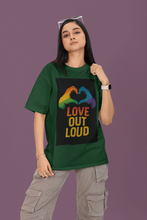 Person wearing a green t-shirt with 'Love Out Loud' design on a purple background