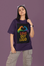 Person wearing a purple t-shirt with a rainbow design and 'Love Out Loud' text on a purple background