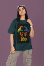 Person wearing a green t-shirt with 'Love Out Loud' graphic on a purple background