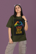 Person wearing a green t-shirt with 'Love Out Loud' design on a purple background