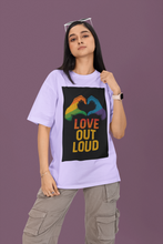 Person wearing a purple t-shirt with a rainbow heart design and 'Love Out Loud' text on a purple background