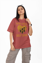 Person wearing a red t-shirt with a motivational message on a white background