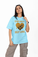 Person wearing a light blue t-shirt with a motivational message on a white background
