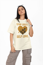 Woman wearing a cream t-shirt with a graphic and text on a white background