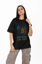 Person wearing a black t-shirt with Bitcoin-themed text on a white background