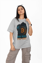 Person wearing a gray t-shirt with Bitcoin symbol and text on a white background