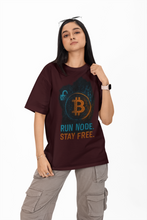 Person wearing a maroon t-shirt with Bitcoin-themed design and text.