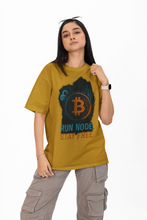Person wearing a mustard yellow t-shirt with Bitcoin graphic and text