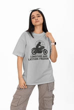 Person wearing a gray t-shirt with a graphic design and text on a white background