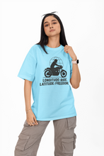 Person wearing a light blue t-shirt with a graphic design and text on a white background