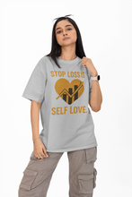 Person wearing a gray t-shirt with a motivational message on a white background