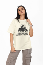 Person wearing a cream t-shirt with a graphic design and text on a white background
