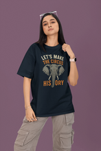 Person wearing a black t-shirt with an elephant graphic and text on a purple background