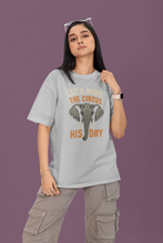 Person wearing a gray t-shirt with an elephant graphic and text on a purple background